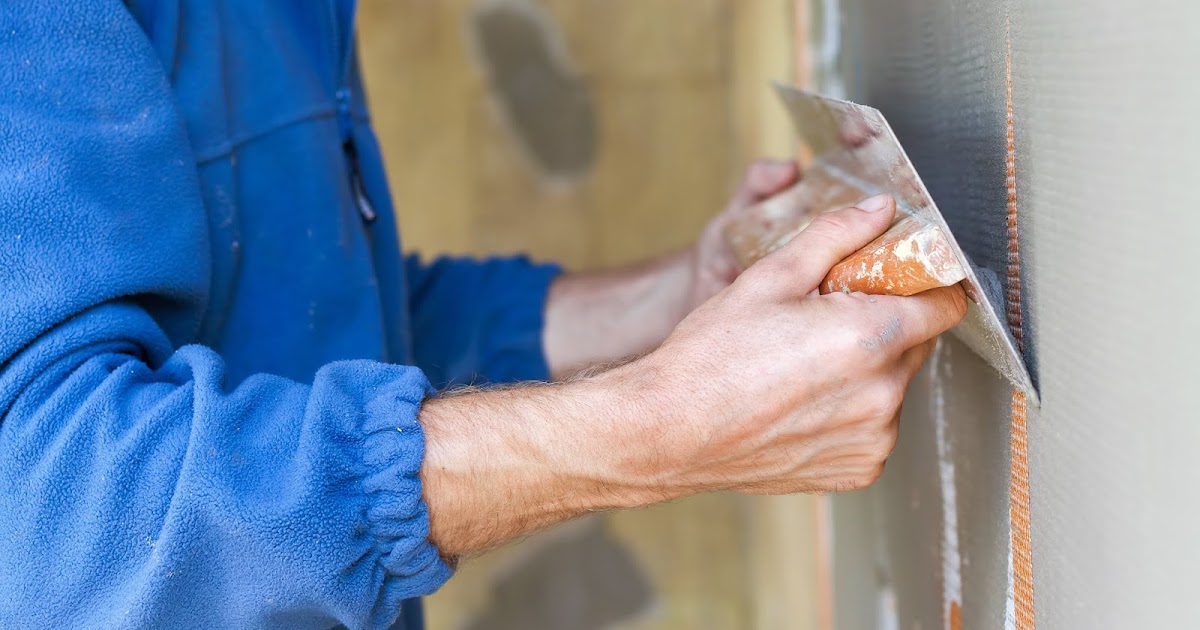men applying Stucco on wall