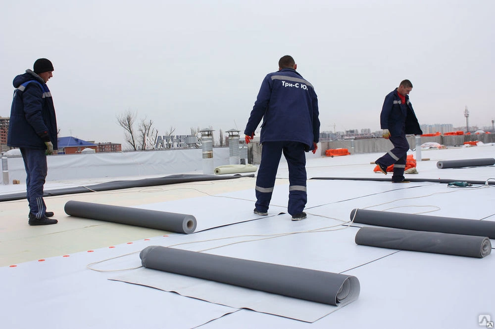 Team member working on roof with built up roofing layers in Brooklyn