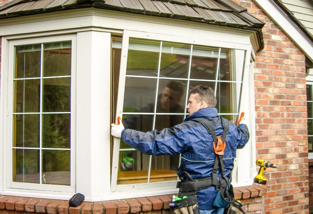 a technician applying new window on new build home